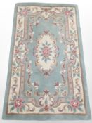 A machine made Chinese rug, on green ground,