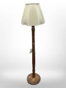 A contemporary turned wooden standard lamp,