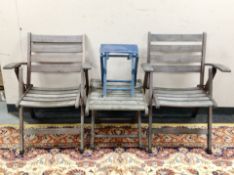 A pair of teak folding garden armchairs,