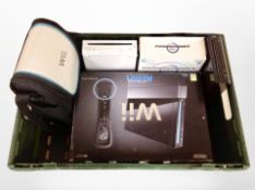 A box of Nintendo Wii consoles and related items.