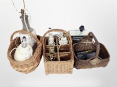 Three wicker baskets containing assorted lamp bases, a contemporary mirrored table lamp.