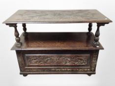 An Edwardian carved oak monk's bench,