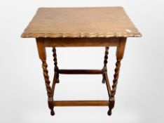 An Edwardian oak scalloped edge barley twist occasional table,