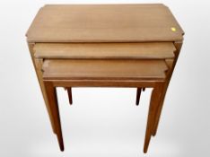 A teak nest of three tables,