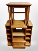 A teak nest of three tables and an entertainment stand