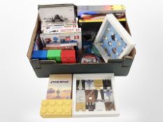 A box containing Lego Star Wars encyclopaedias, Star Wars the Clone Wars DVDs, visual dictionaries,