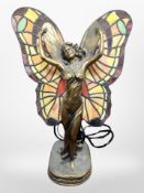 A contemporary Tiffany-style resin and glass table lamp modelled as a lady with outstretched