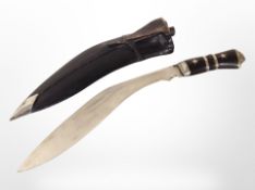 A kukri knife in sheath.