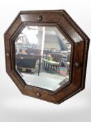 An Edwardian carved oak octagonal mirror, width 44cm.