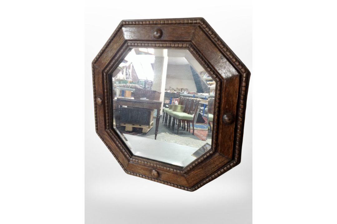 An Edwardian carved oak octagonal mirror, width 44cm.