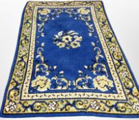 A 20th century woolen rug on blue ground, 196cm x 125cm.