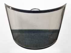 A metal bowfront fire guard,