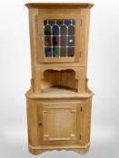 A Danish blonde oak leaded glass door standing corner cabinet,