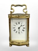 A brass-cased carriage clock, white dial with Roman numerals, platform escapement,