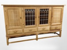 A Danish blonde oak leaded glass door sideboard,