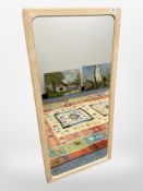 A contemporary pine-framed mirror, 55cm x 115cm.