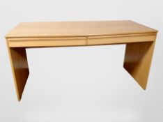 A contemporary pine effect PC desk,