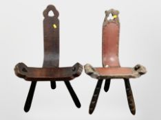 Two early 20th-century carved and stained pine tripod stools.