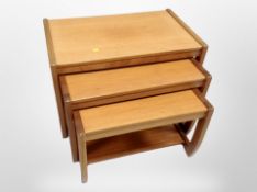 A teak nest of three tables, 71cm x 44cm x 50cm.