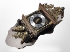 A continental wall clock with brass peardrop weights, length 61cm.