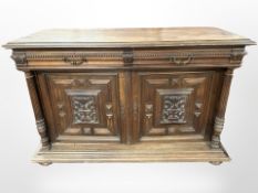 A 19th-century French carved oak double-door sideboard on bun feet, 153cm x 59cm x 100cm.