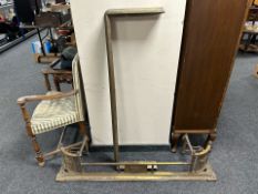 Two Victorian brass fire curbs.