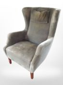 An early 20th century wingback armchair
