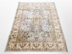 A machine-made Persian-design rug on blue ground, 161cm x 117cm.