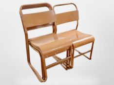 A set of four mid 20th-century metal and laminated wood stacking chairs.