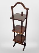 An Edwardian mahogany three-tier folding cake stand, height 101cm.