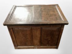 An early 19th-century panelled oak coffer, 71cm x 49cm x 53cm.
