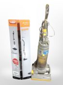 A Dyson DC04 upright vacuum cleaner, and a Vax steam cleaner in box.