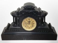 A 19th-century slate mantel clock with visible escapement to dial, height 35cm.