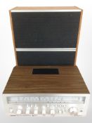 A Bush FM Stereo receiver and a pair of Tandberg TL 1520 teak-cased speakers.