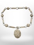 A white metal embossed locket on chain, 48.4g.