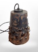 A 1970s Scandinavian amber glass conical light fitting with metal overlay,