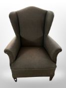 An early 20th century wingback armchair