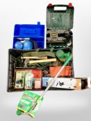 A box of tools including Bosch sander, plant-watering lance, hand tools, collapsible camera tripod,