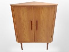 A 1970s Danish teak double-door corner cabinet on tapered legs, height 111cm.