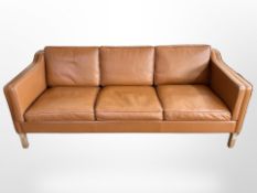A late 20th-century Danish tan leather three-seater settee, 202cm x 83cm x 80cm.