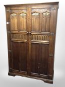 An oak linen-fold double-door wardrobe,