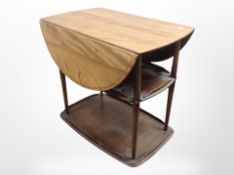 An Ercol elm drop-leaf serving trolley, 73cm x 45cm x 73cm (unfolded).