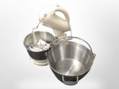 A food mixer and an aluminium swing-handled pan.