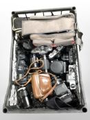 A crate of vintage cameras and lenses including Fujica, Praktica, etc.