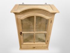 A Danish blonde oak glazed single-door wall cabinet, 52cm x 27cm x 70cm.