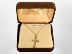 A 9ct gold crucifix pendant, two silver napkin rings, and five silver-handled butter knives.