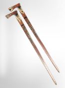 A pair of decorative carved wooden axes, length 92cm.