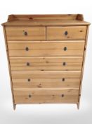 A contemporary pine effect six-drawer chest, 95cm x 50cm x 123cm.