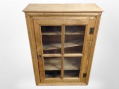 A 19th-century pine glazed door wall cabinet, 73cm x 30cm x 100cm.