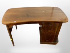 An early 20th-century Danish walnut inverted bow-front single pedestal writing desk,